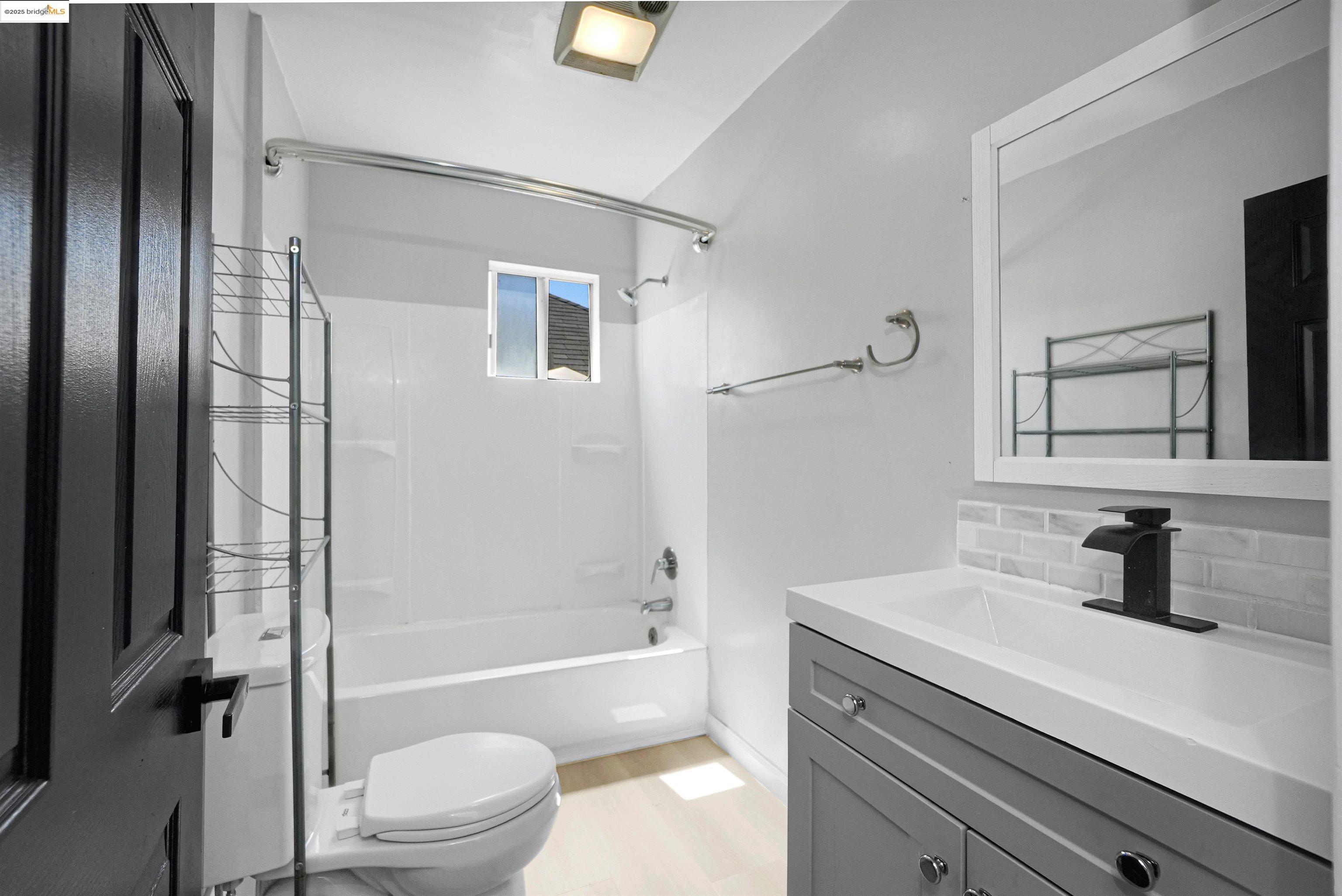 2207 East 19th Street Oakland, CA 94606 - Photo 22 of 30 a bathroom with a sink a toilet and shower