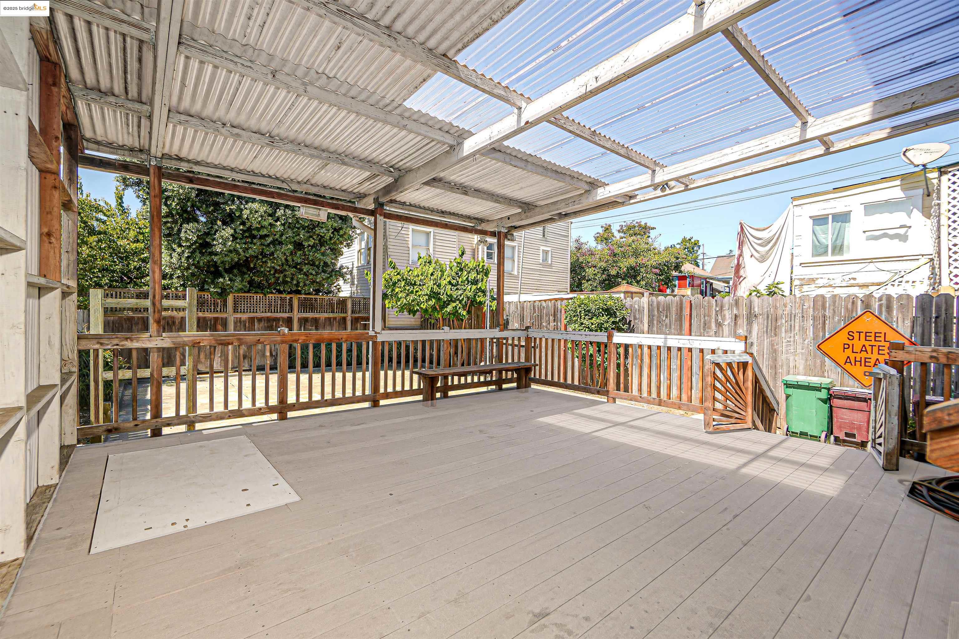 2207 East 19th Street Oakland, CA 94606 - Photo 25 of 30 a view of a porch with wooden floor and iron stairs
