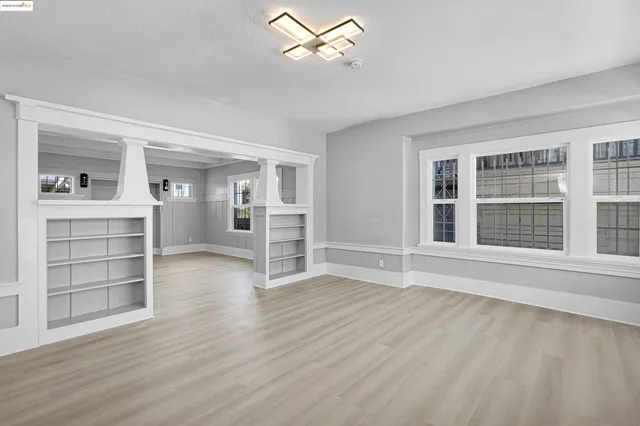 wooden floor in an empty room with a window