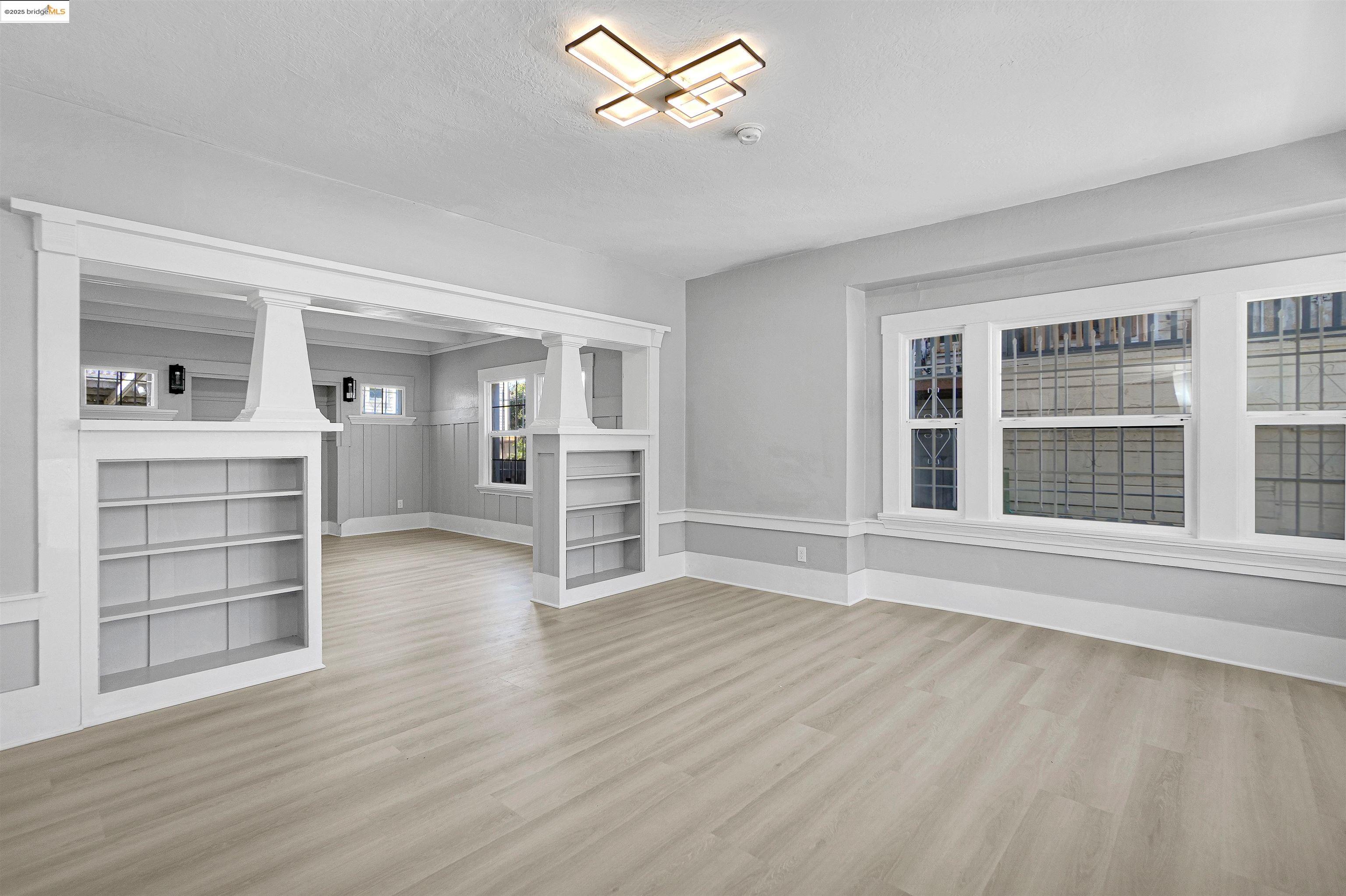 2207 East 19th Street Oakland, CA 94606 - Photo 4 of 30 wooden floor in an empty room with a window