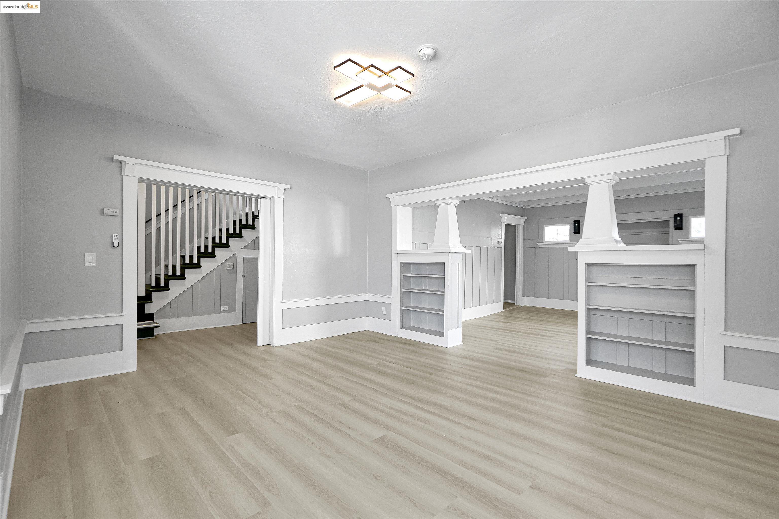 2207 East 19th Street Oakland, CA 94606 - Photo 5 of 30 wooden floor in an empty room with a window
