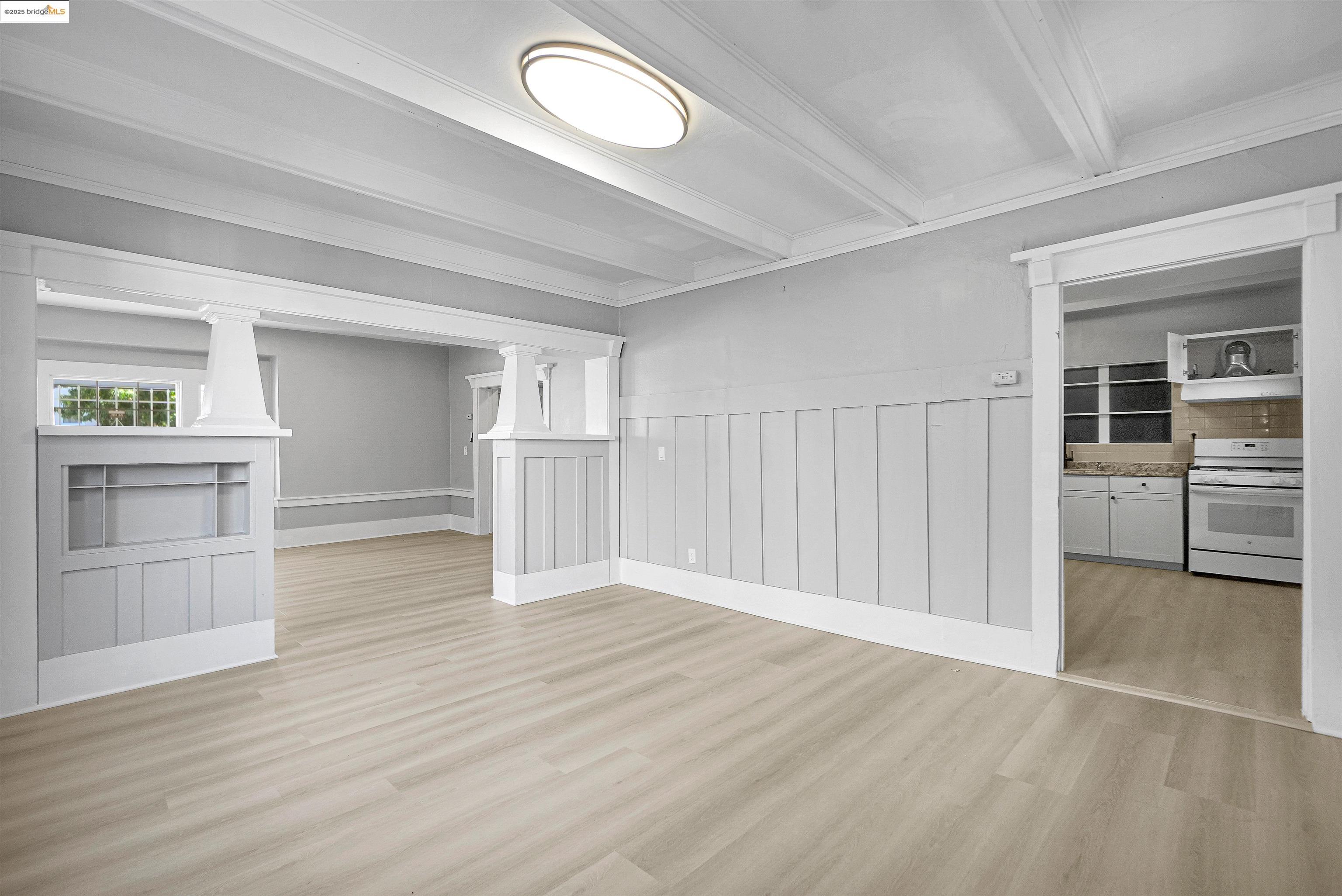 2207 East 19th Street Oakland, CA 94606 - Photo 8 of 30 an empty room with wooden floor and windows