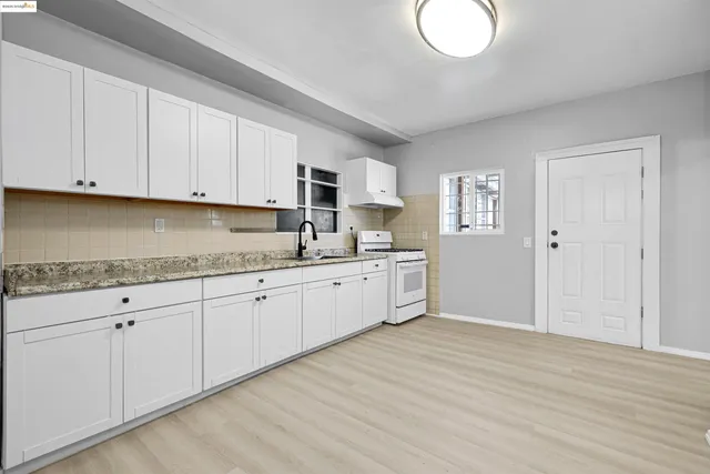 a view of a room with wooden floor and white walls
