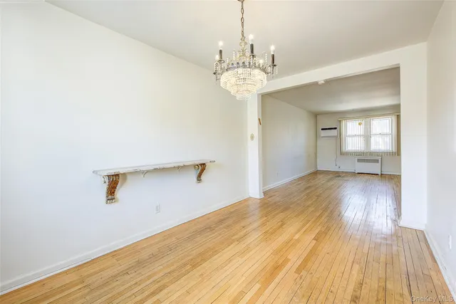 a view of a room with wooden floor and windows