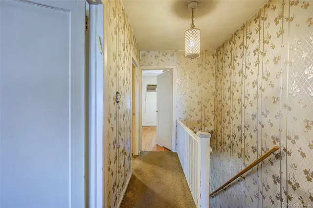 a view of a room with wooden floor and a window