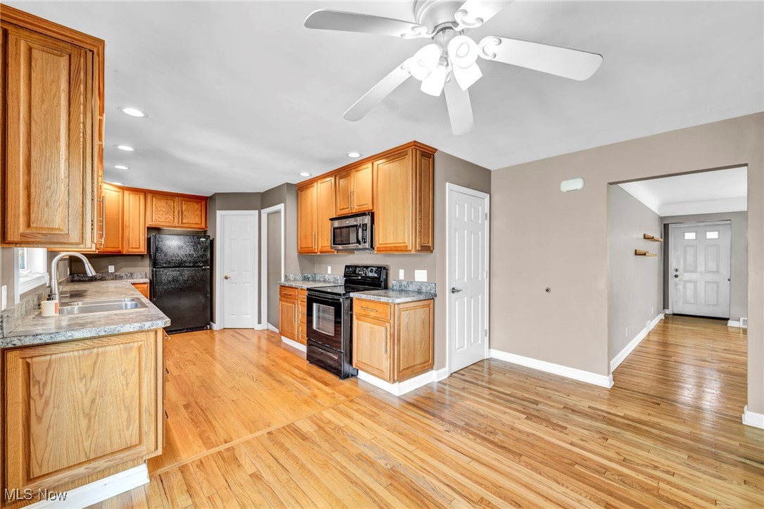 4523 Oakes Road Brecksville, OH 44141 - Photo 12 of 50 Kitchen with black appliances, recessed lighting, light wood-style flooring, ceiling fan, and brown cabinets