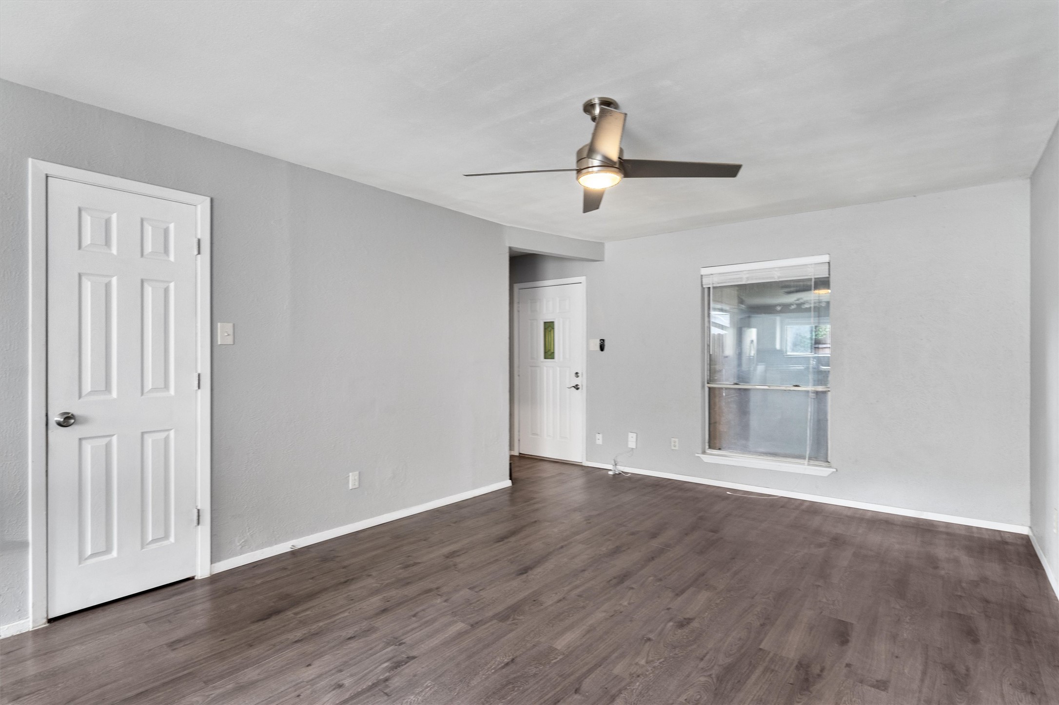 wooden floor in an empty room with a window
