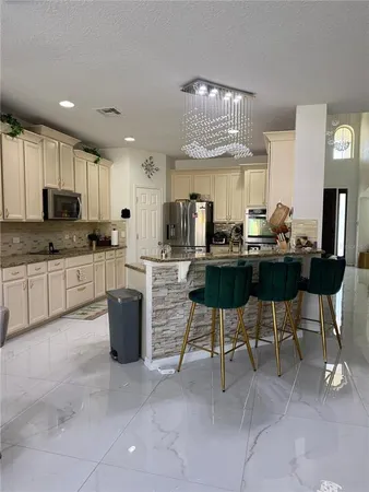 a kitchen with a table chairs microwave and cabinets