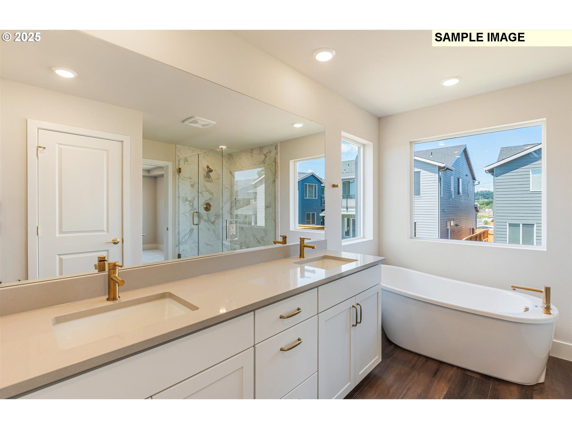 6749 Southwest Windflower Street Wilsonville, OR 97070 - Photo 12 of 33 a bathroom with a double vanity sink a mirror and a bathtub