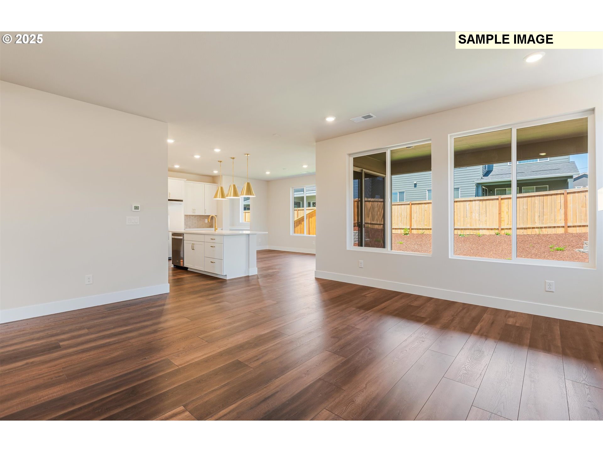 6749 Southwest Windflower Street Wilsonville, OR 97070 - Photo 3 of 33 a view of empty room with wooden floor and windows