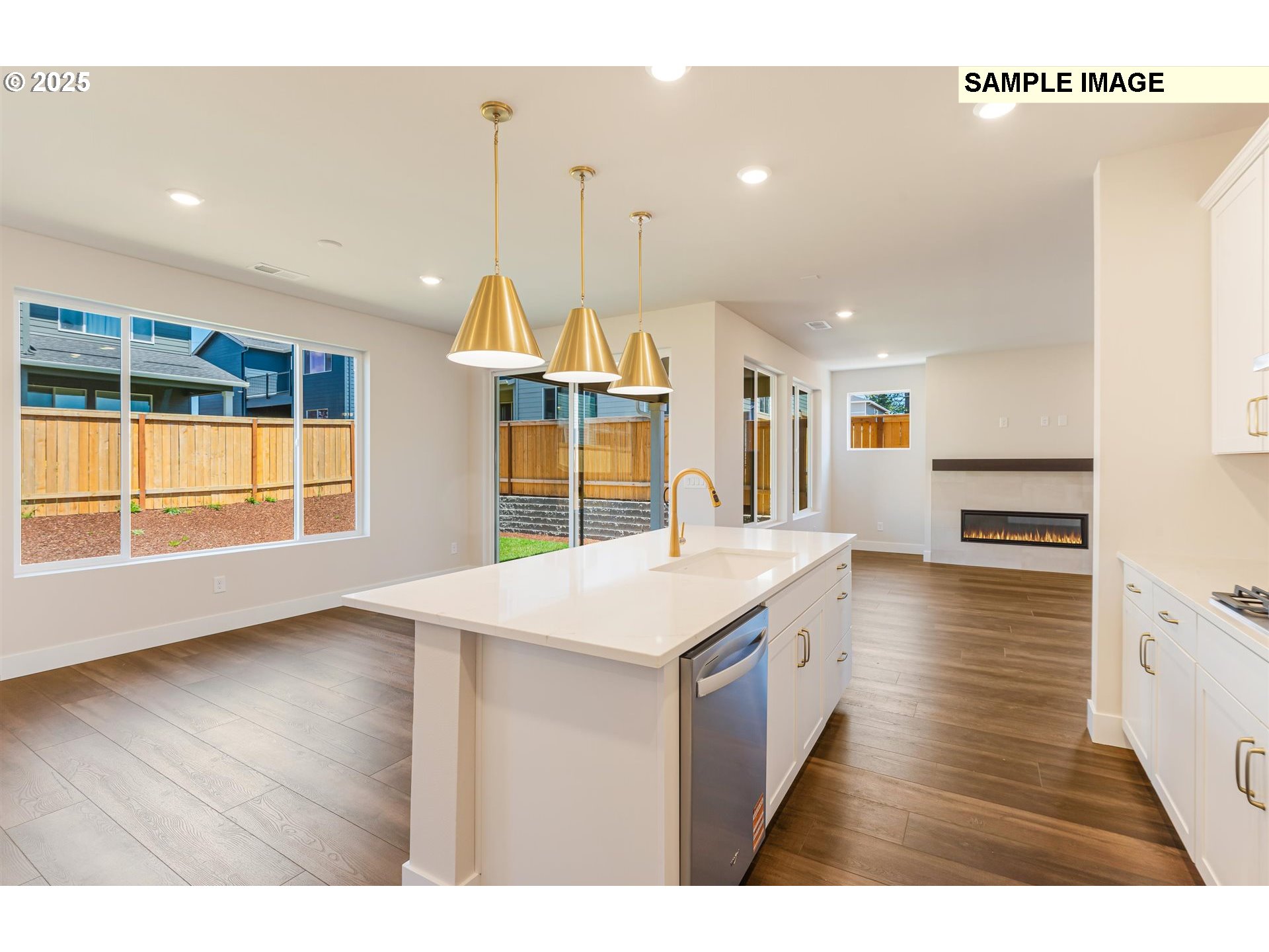 6749 Southwest Windflower Street Wilsonville, OR 97070 - Photo 7 of 33 a open kitchen with stainless steel appliances granite countertop a sink a oven a dining table and chairs with wooden floor