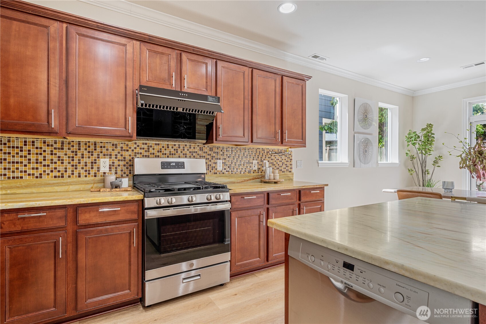 9528 25th Drive Southeast Everett, WA 98208 - Photo 13 of 36 a kitchen with granite countertop a stove top oven microwave and cabinets