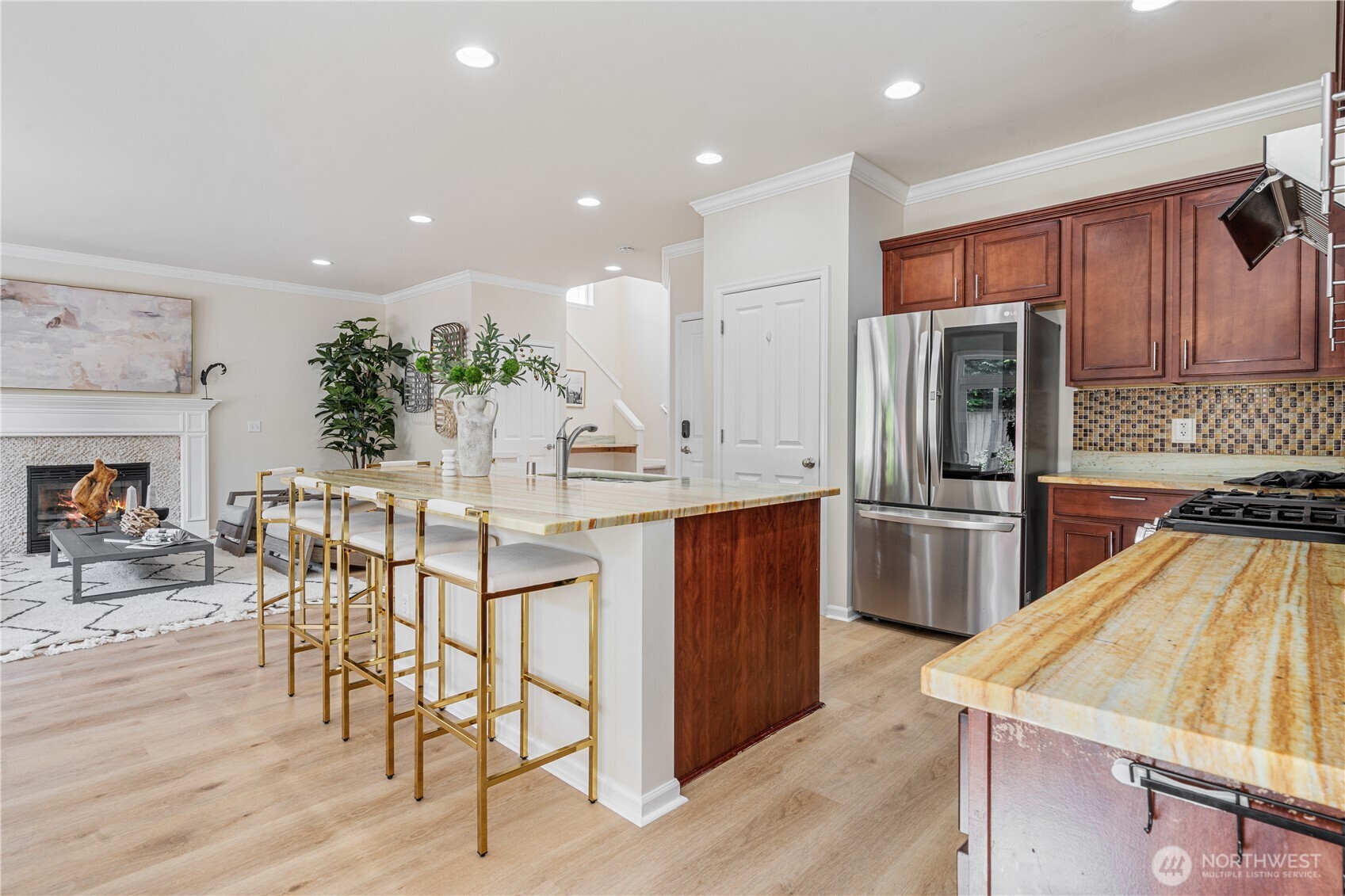 9528 25th Drive Southeast Everett, WA 98208 - Photo 16 of 36 a kitchen with stainless steel appliances kitchen island granite countertop a refrigerator a stove a sink a dining table and chairs with wooden floor
