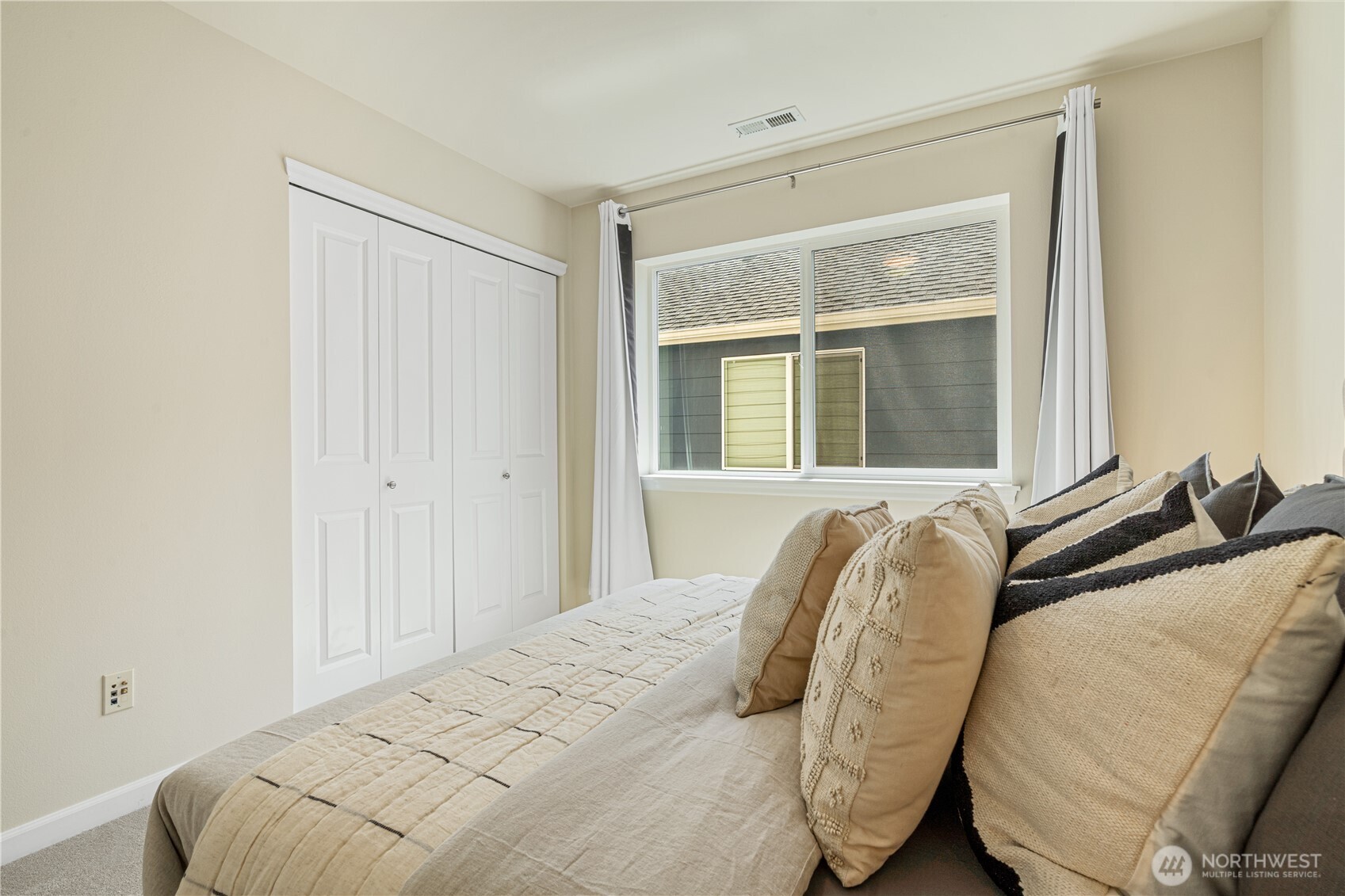 9528 25th Drive Southeast Everett, WA 98208 - Photo 29 of 36 a bed sitting in a bedroom next to a window