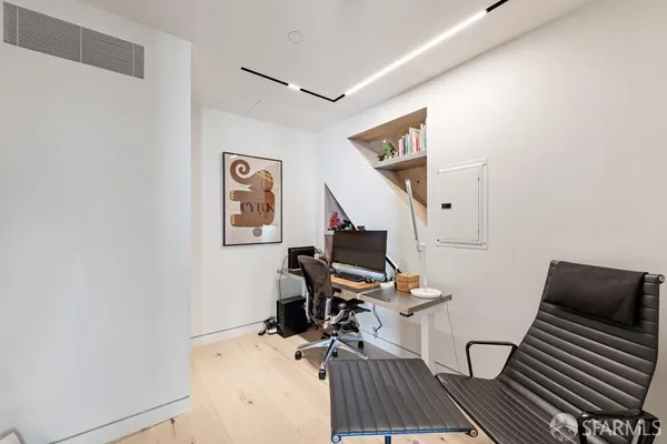 a bedroom with a bed and glass window