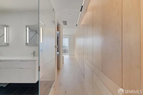 a bathroom with a tub sink and mirror