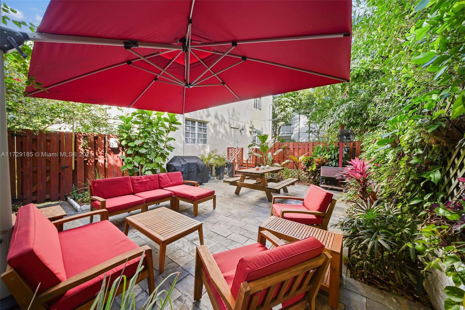 a view of a outdoor sitting area with furniture and umbrella