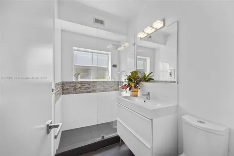 a bathroom with a sink a vanity and a mirror