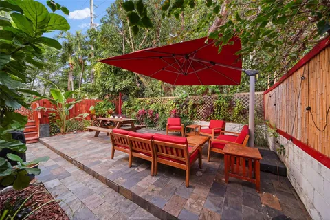 an outdoor sitting area with umbrella and umbrella