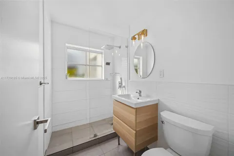 a bathroom with a toilet a sink and mirror