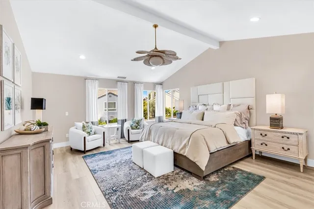 a bedroom with bed and a chandelier