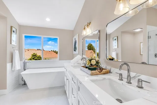 a bathroom with a double vanity sink and a bathtub