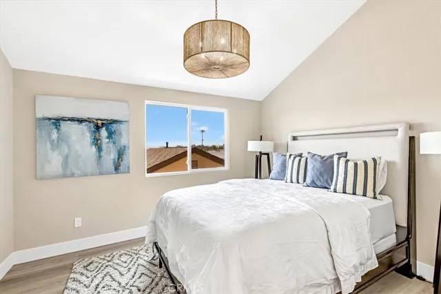 a bedroom with a large bed and a chandelier