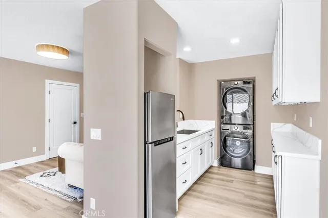 a kitchen with stainless steel appliances granite countertop a refrigerator and a stove