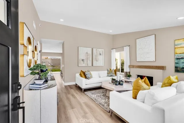 a living room with furniture fireplace and potted plants