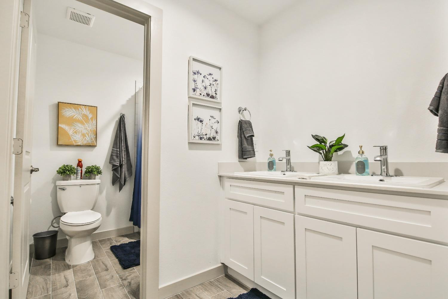 6802 55th Street Lubbock, TX 79407 - Photo 15 of 36 a bathroom with a sink a toilet and a mirror