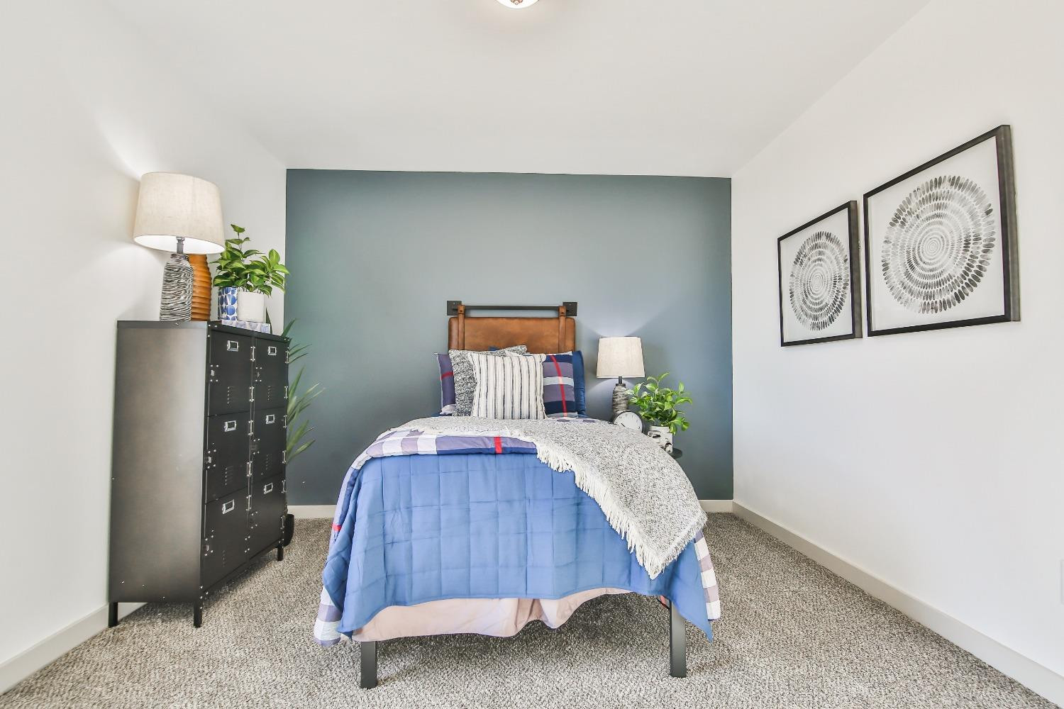 6802 55th Street Lubbock, TX 79407 - Photo 19 of 36 a bedroom with a bed and wooden floor