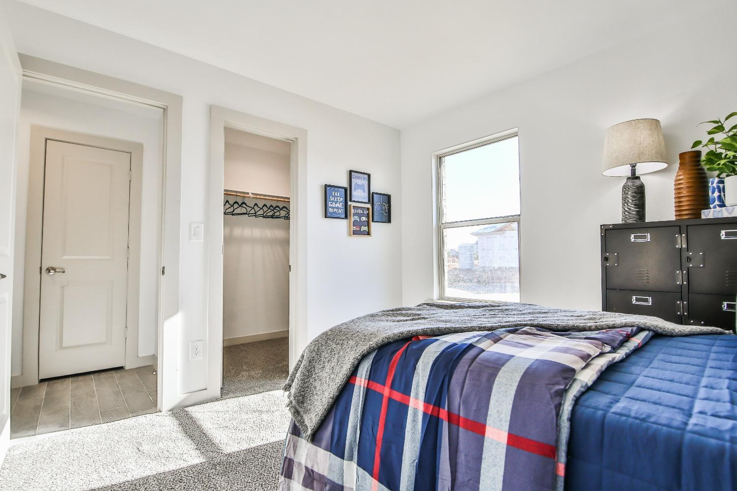 6802 55th Street Lubbock, TX 79407 - Photo 20 of 36 a bedroom with a bed and a window