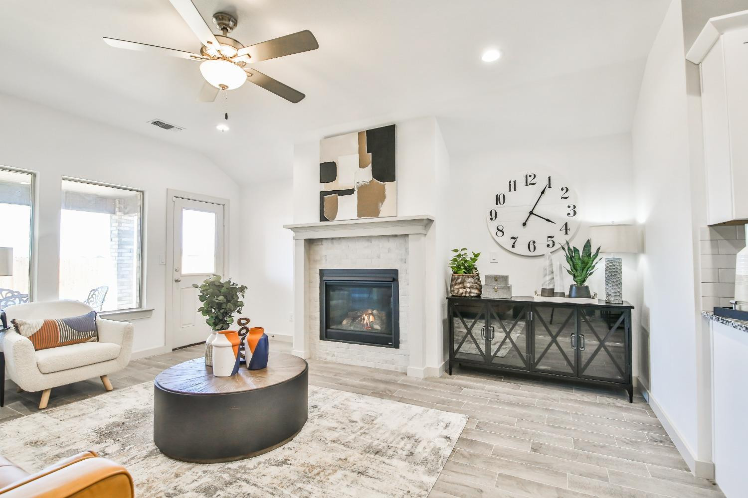 6802 55th Street Lubbock, TX 79407 - Photo 26 of 36 a living room with furniture and a fireplace