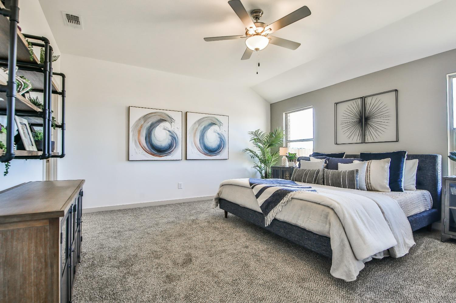 6802 55th Street Lubbock, TX 79407 - Photo 4 of 36 a bedroom with a bed lamp and painting on the wall