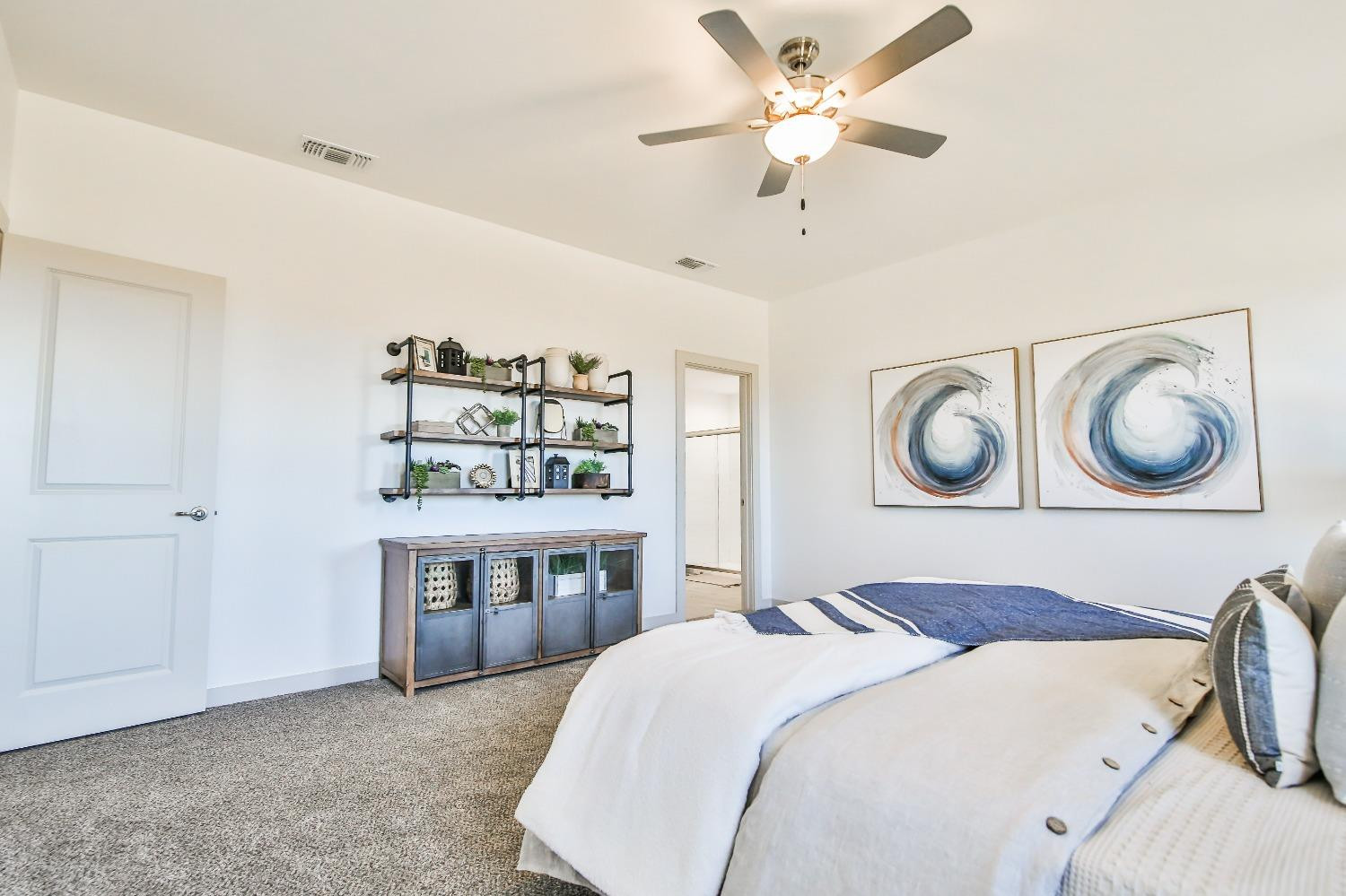 6802 55th Street Lubbock, TX 79407 - Photo 5 of 36 a bedroom with a bed and a chandelier