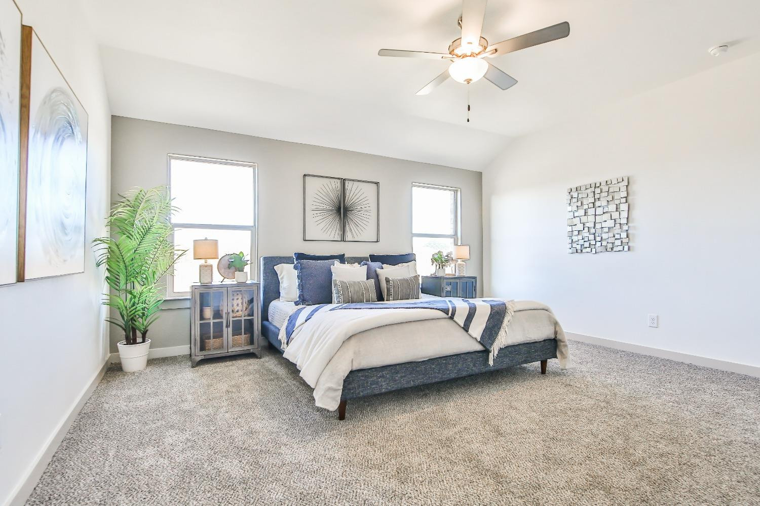 6802 55th Street Lubbock, TX 79407 - Photo 6 of 36 a spacious bedroom with a bed and a chandelier