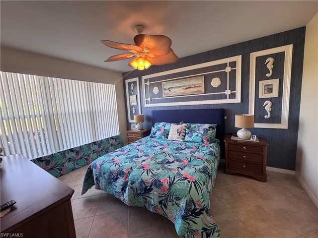 a bedroom with a bed and ceiling fan