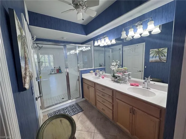 a bathroom with a sink vanity granite and a mirror