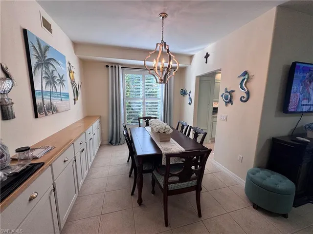 a view of a dining room with furniture window and chandelier