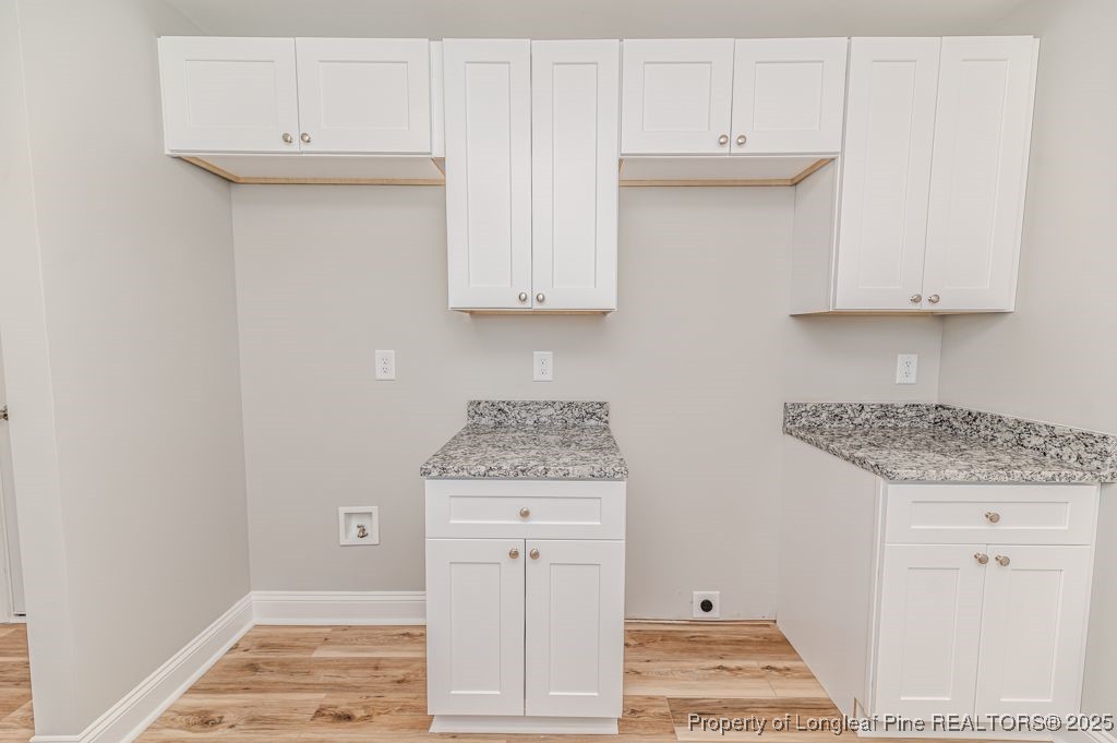 932 Allstar Avenue Cameron, NC 28326 - Photo 14 of 33 a kitchen with granite countertop a white stove top oven and cabinets