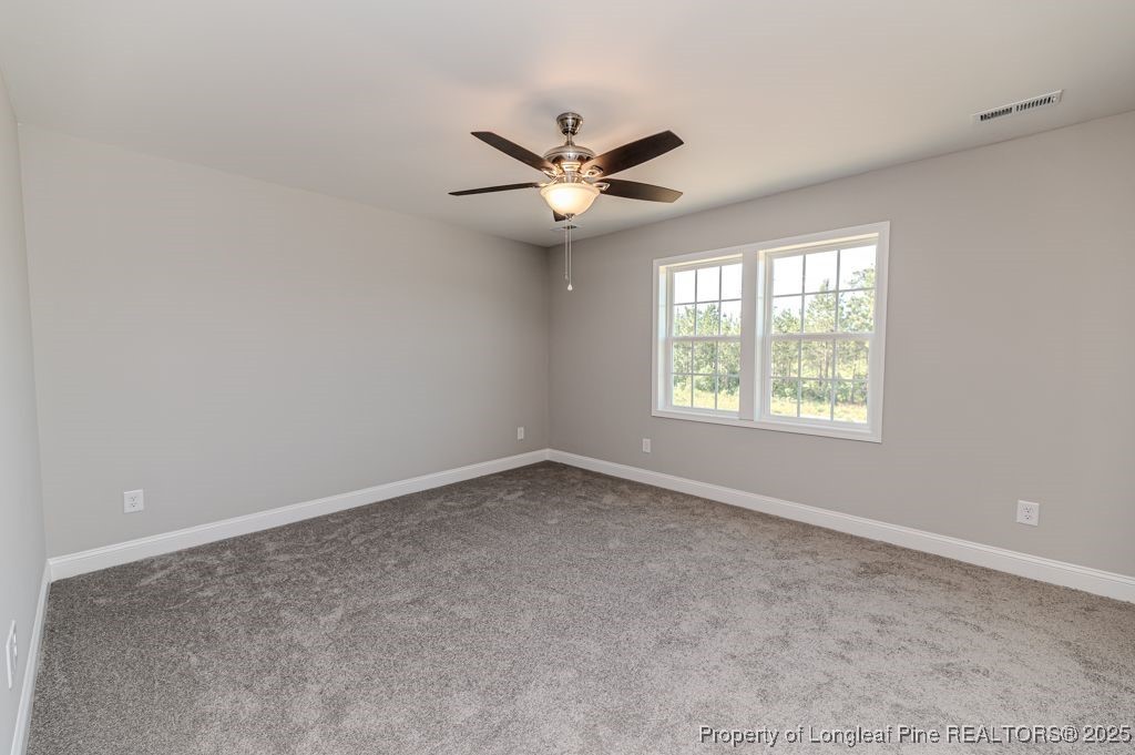932 Allstar Avenue Cameron, NC 28326 - Photo 23 of 33 an empty room with a window and a fan