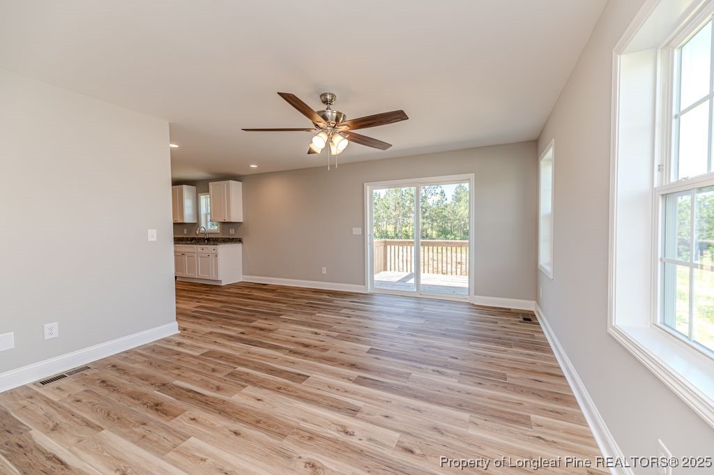 932 Allstar Avenue Cameron, NC 28326 - Photo 7 of 33 wooden floor in an empty room with a window