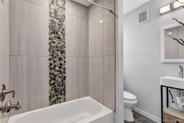 a bathroom with a toilet and a shower