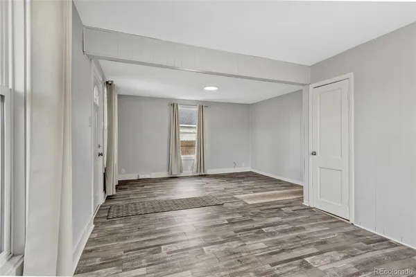 a view of a livingroom with wooden floor and closet