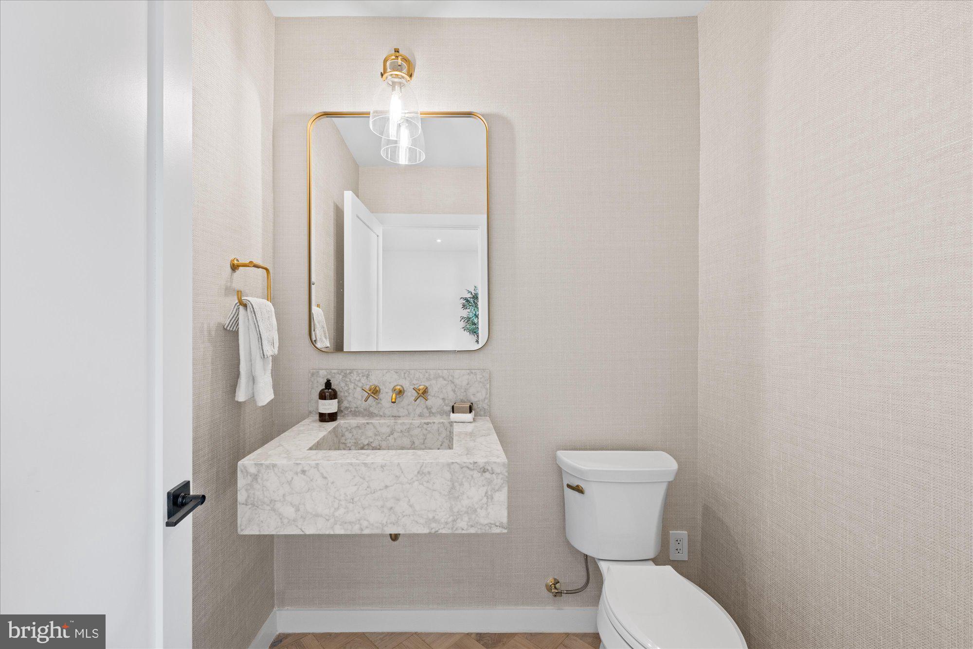 1319 R Street Northwest, Unit 2100 Washington, DC 20009 - Photo 17 of 36 a bathroom with a toilet sink and mirror