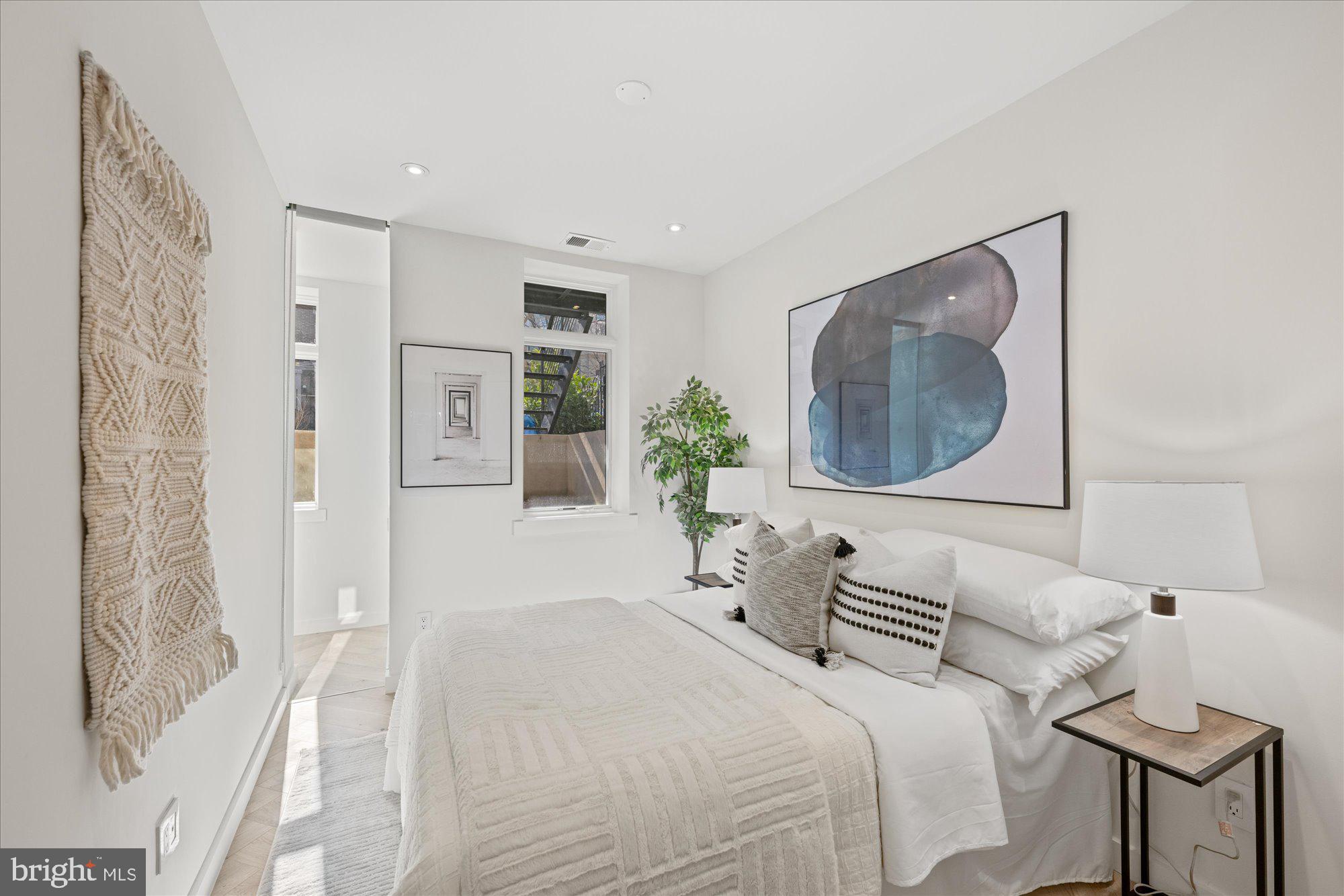 1319 R Street Northwest, Unit 2100 Washington, DC 20009 - Photo 31 of 36 a bedroom with a bed and a mirror