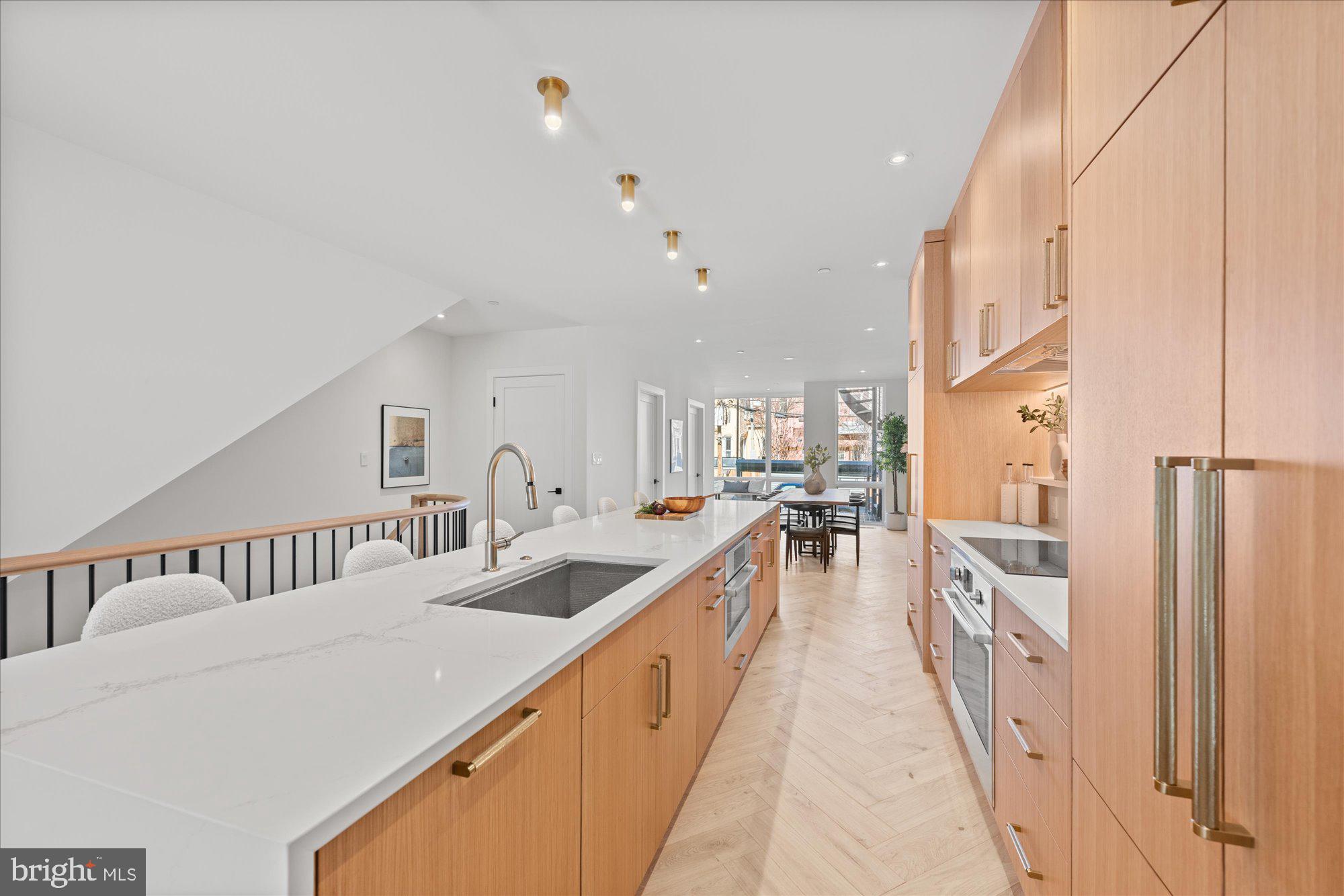 1319 R Street Northwest, Unit 2100 Washington, DC 20009 - Photo 9 of 36 a large white kitchen with sink and refrigerator