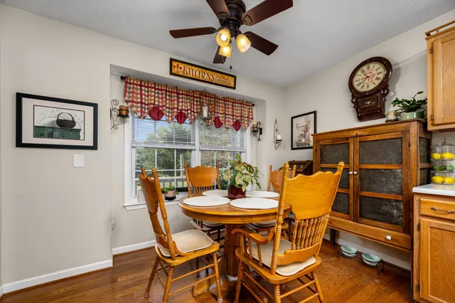 a dining room with furniture and wooden floor