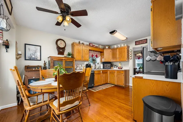 a dining room with furniture and a large window