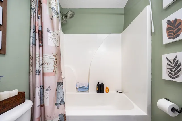 a view of staircase with railing and white walls